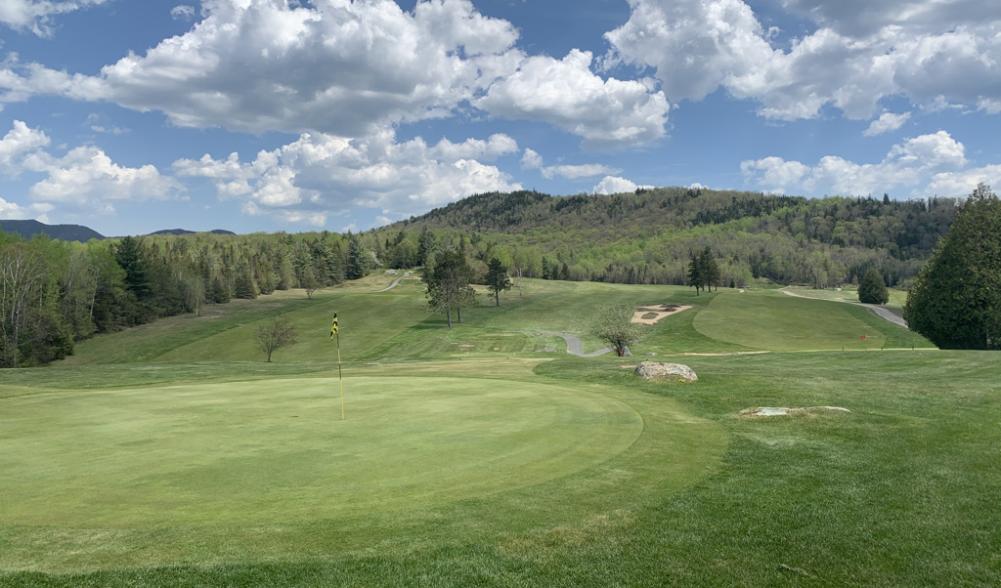 The #9 hole and the #8 green at Craig Wood Golf Club, with low mountains in the background.