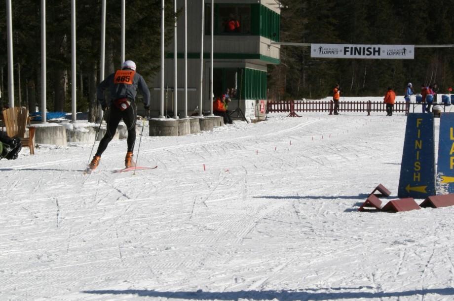 A competitor finishes the grueling Lake Placid Loppet