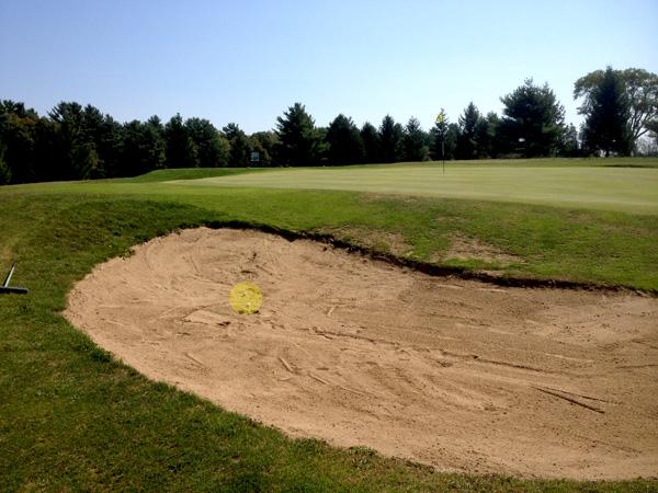 TWO balls in the sand trap at the Westport Country Club