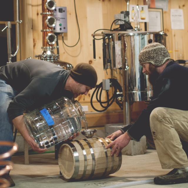 Pouring the Apple Brandy into the wooden barrels!