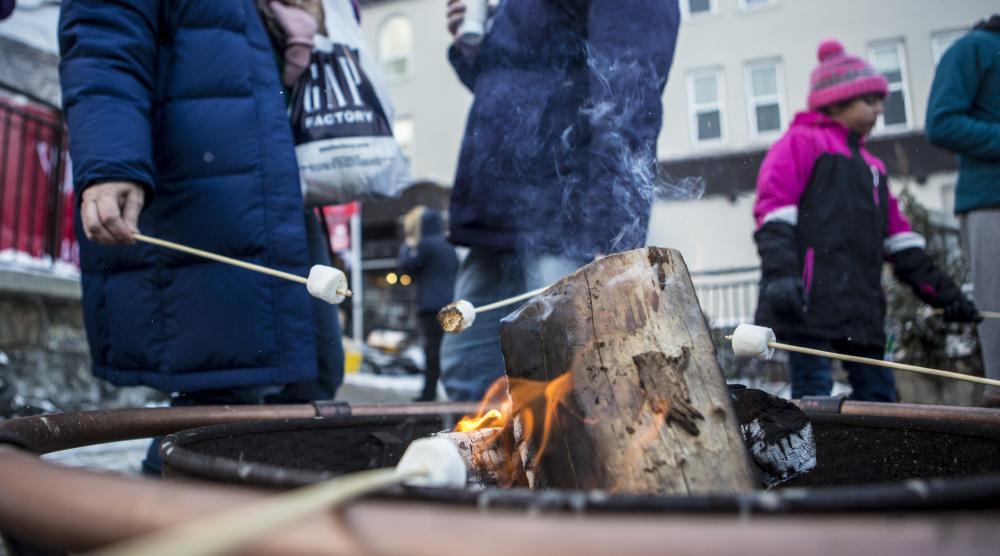 Close-up of roasting marshmallows on a firepit downtown.