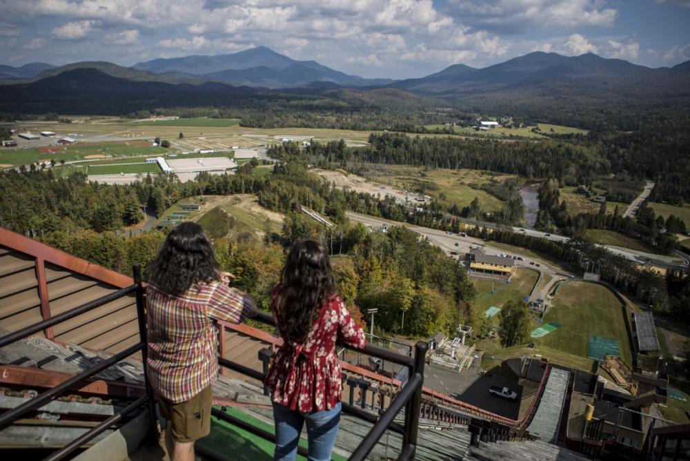 A young couple takes in the views from the top of one of the ski jumps in Lake Placid