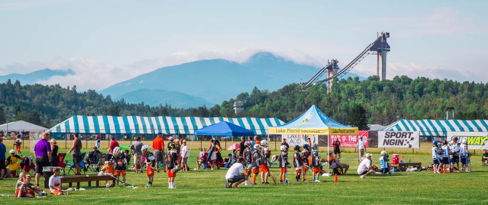 The Olympic ski jumps are seen in the background from a lacrosse tournament