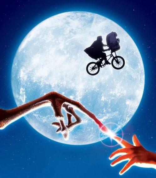 A graphic from the movie E.T. the extra-terrestrial, showing the moon as a backdrop to Elliott riding his bicycle with E.T. in the basket