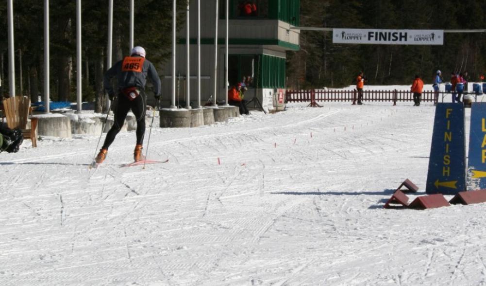 A competitor finishes the grueling Lake Placid Loppet