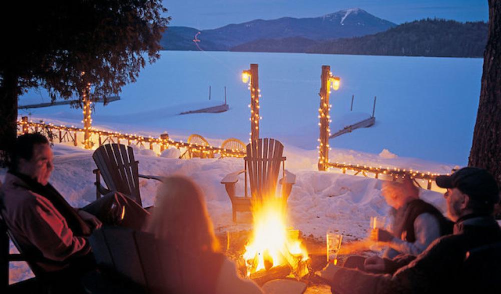 Look over frozen Lake Placid to Whiteface Mountain beyond, while a blazing firepit warms us outside, and eat and drink to warm our inside.