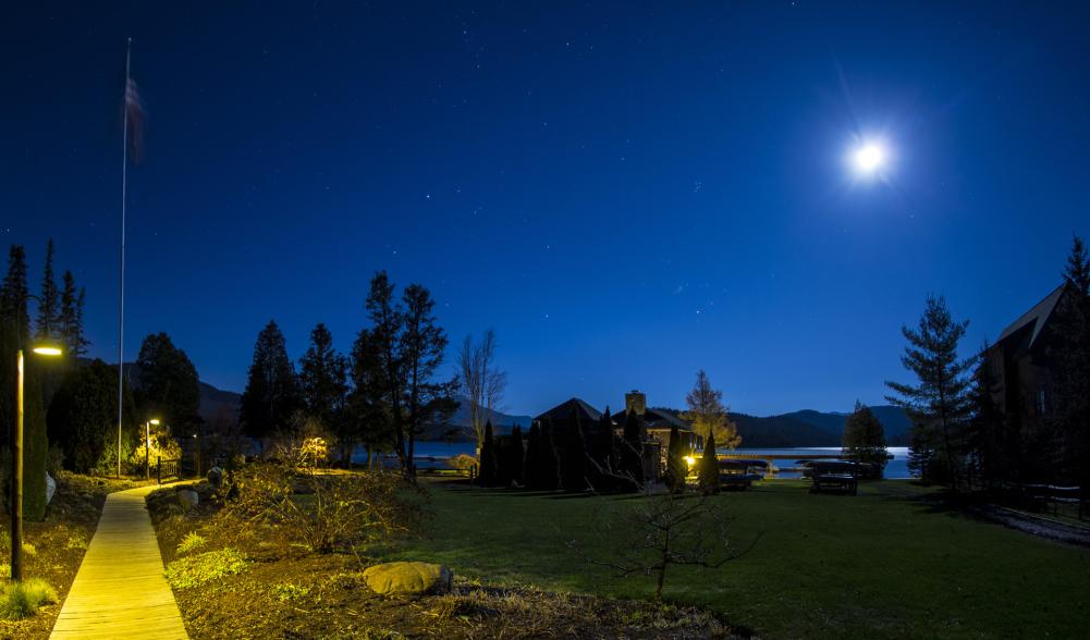 Whiteface Club grounds at night during a full moon, near a lake.