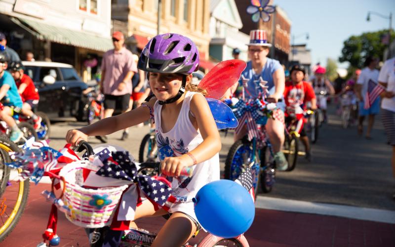 Kid rides a decorated bike in the parade