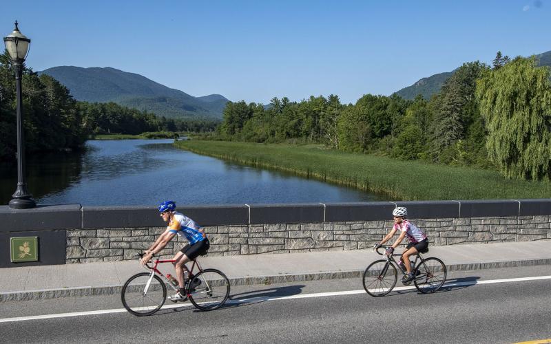 Cyclists crossing bridge over Ausable River