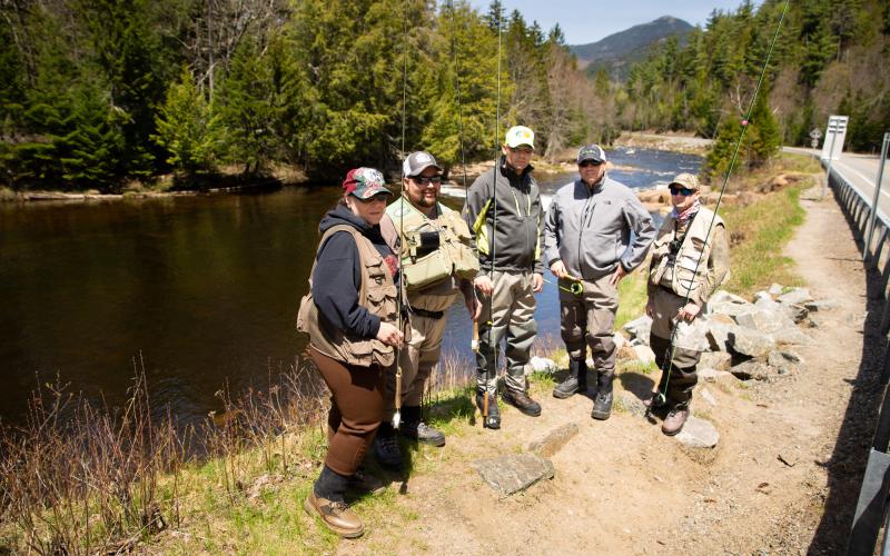 Anglers gather for photo next to river