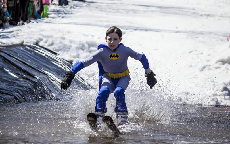 Child pond skimming dressed as batman
