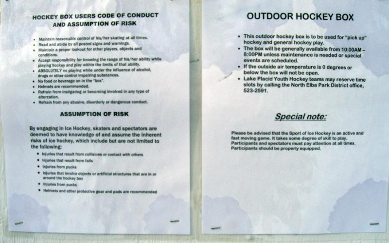 Two laminated papers explaining rules of a hockey box.