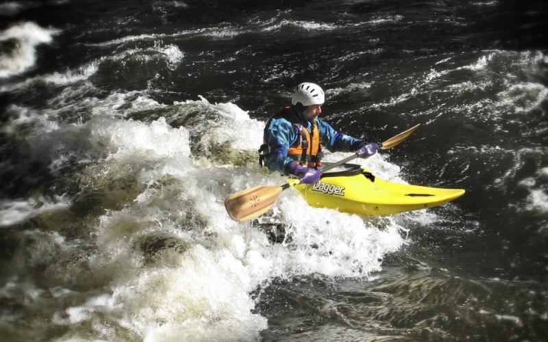 A whitewater kayaker negotiating rapids