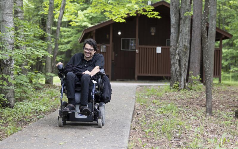 A man in a wheelchair in a campground