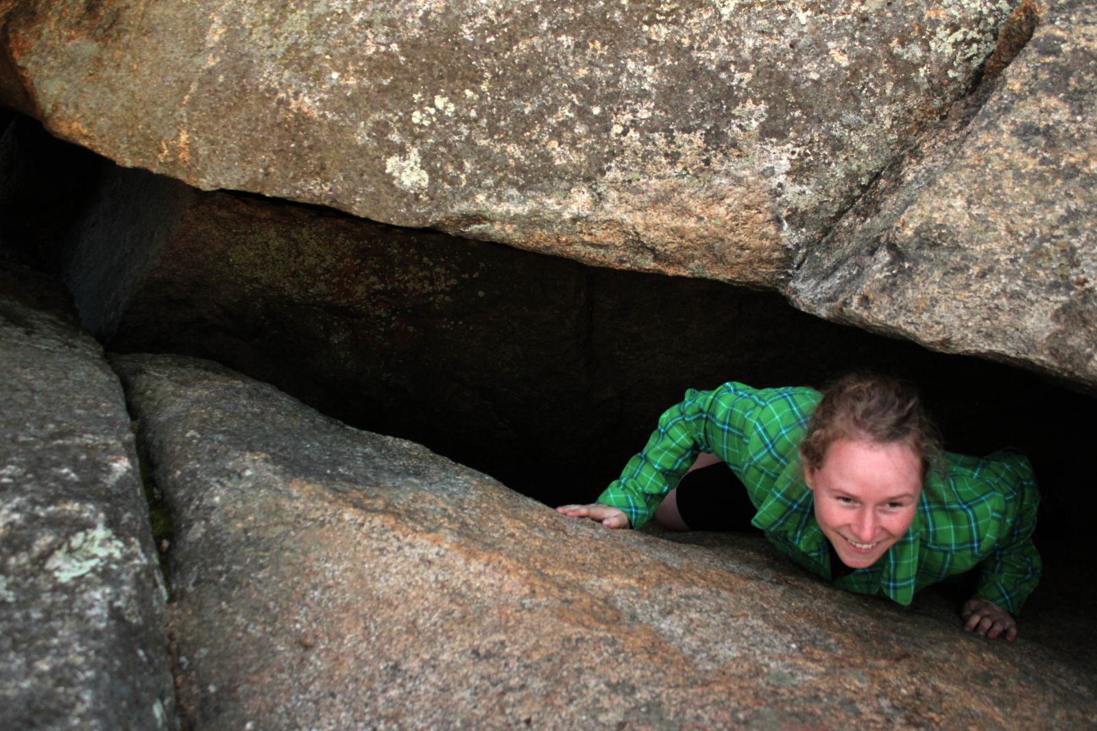 Emilee exits the cave-like crack in the ledge.