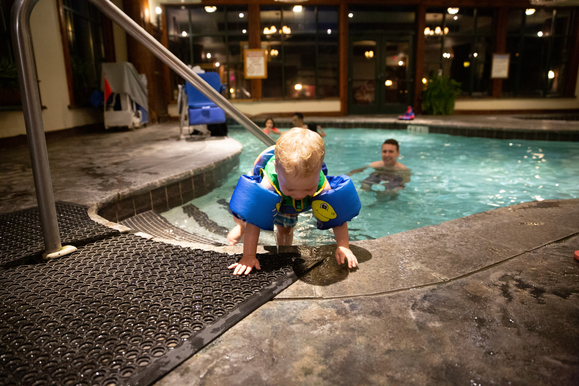 A family enjoys a small indoor pool in Lake Placid in the winter.