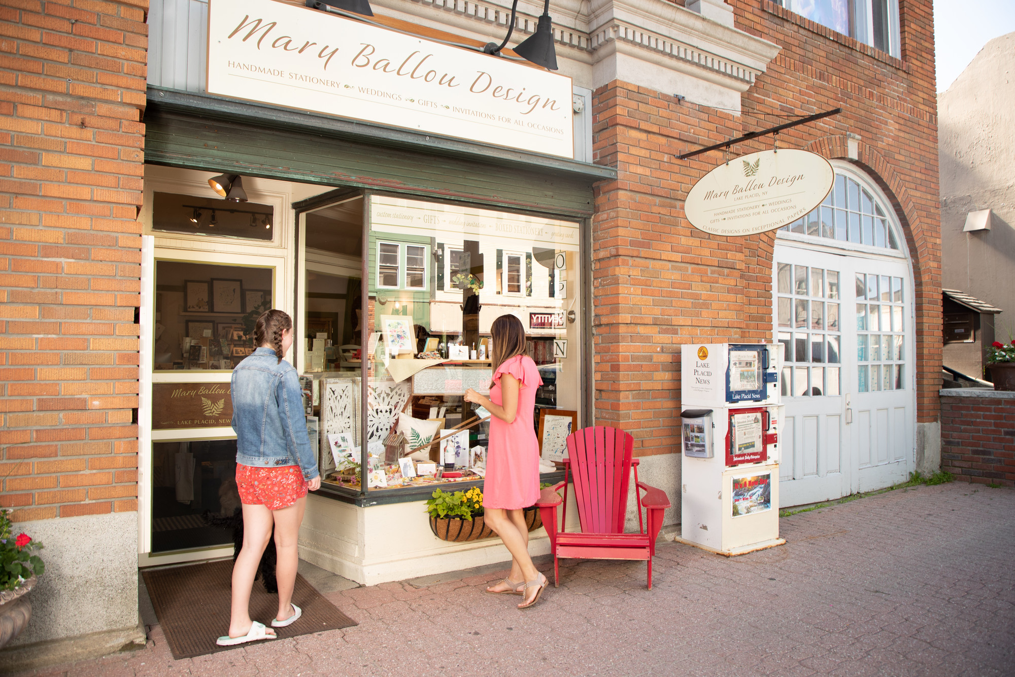 Two women browse Lake Placid's Main Street in the summer.