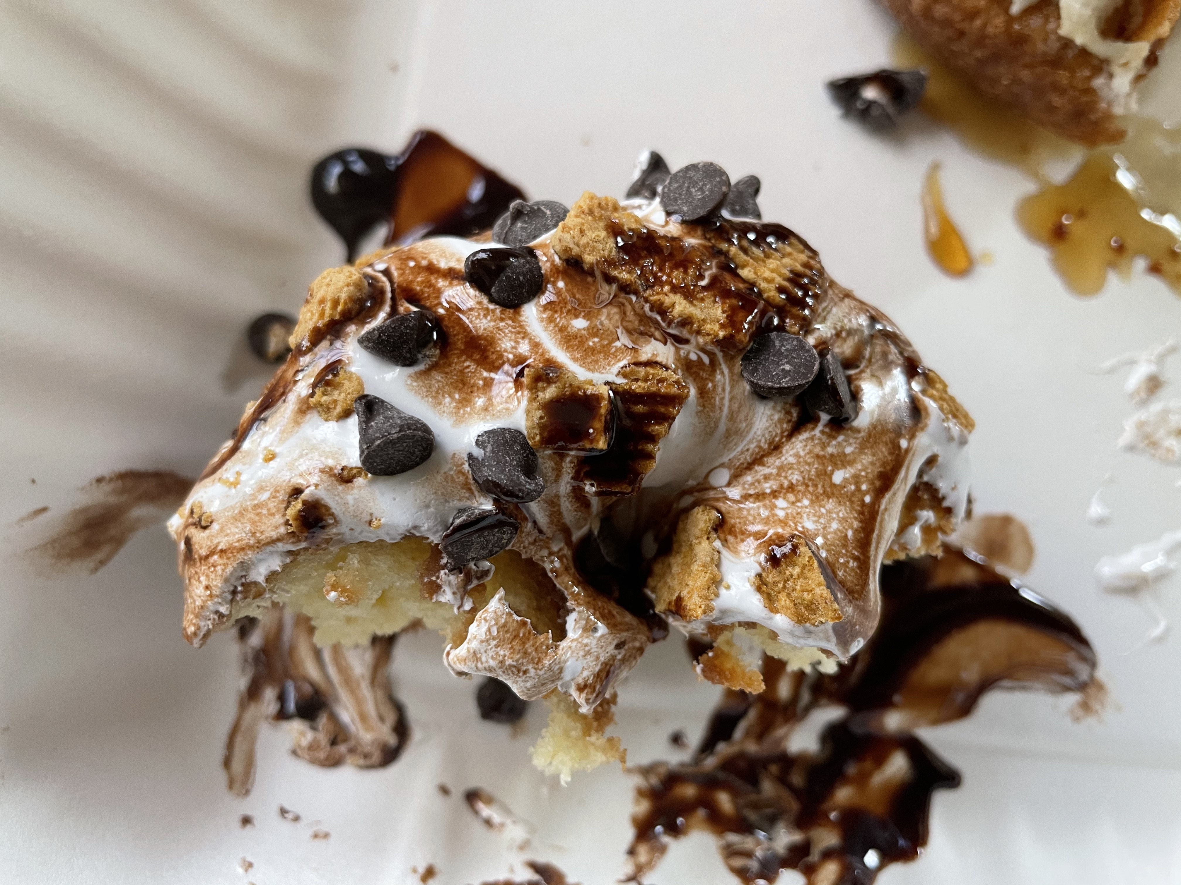 Close-up of what's left of a Campfire Donut&#44; with chocolate chips and marshmallow on top.