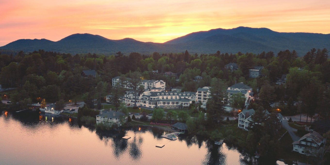 Wide aerial view of the Mirror Lake Inn's numerous buildings overlooking Mirror Lake. Image courtesy Mirror Lake Inn.