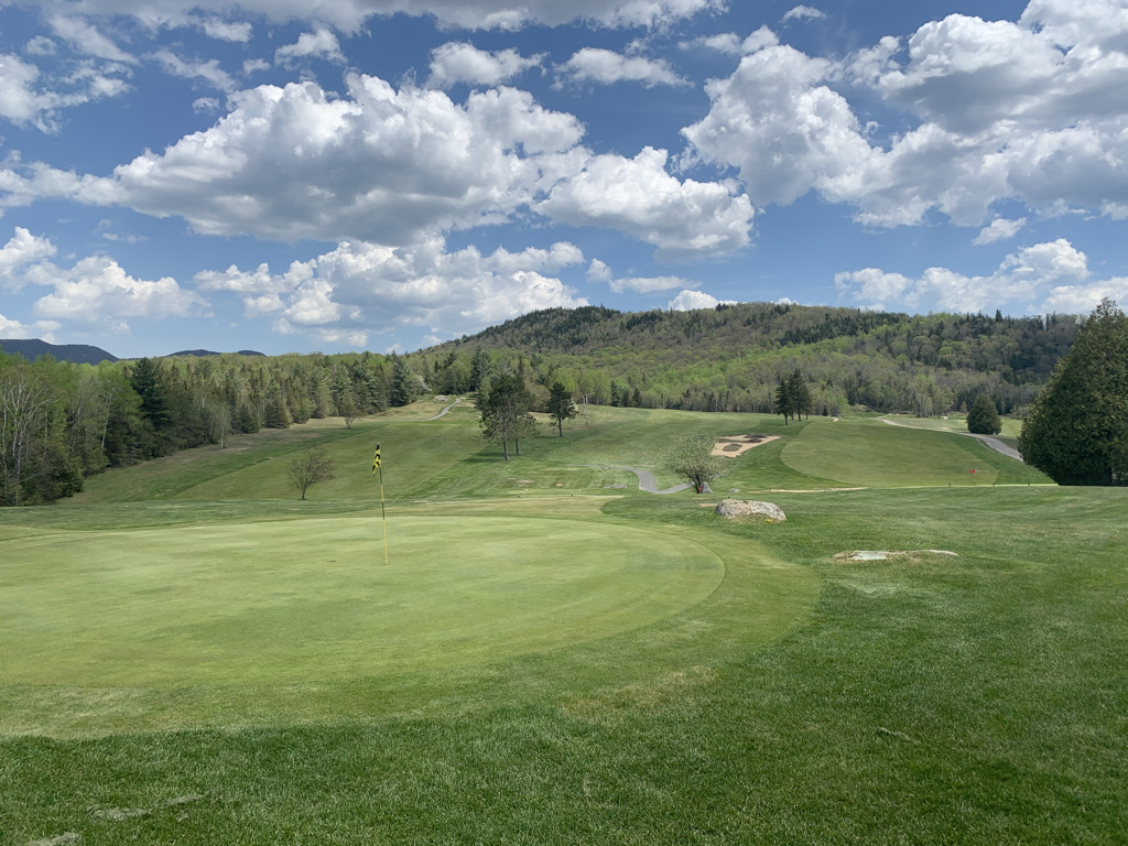 The #9 hole and the #8 green at Craig Wood Golf Club&#44; with low mountains in the background.
