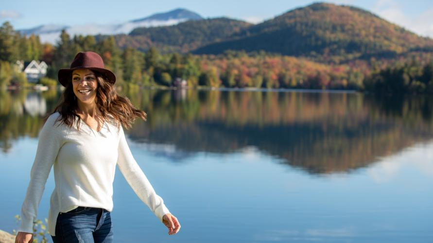 A woman walks along mirror lake 