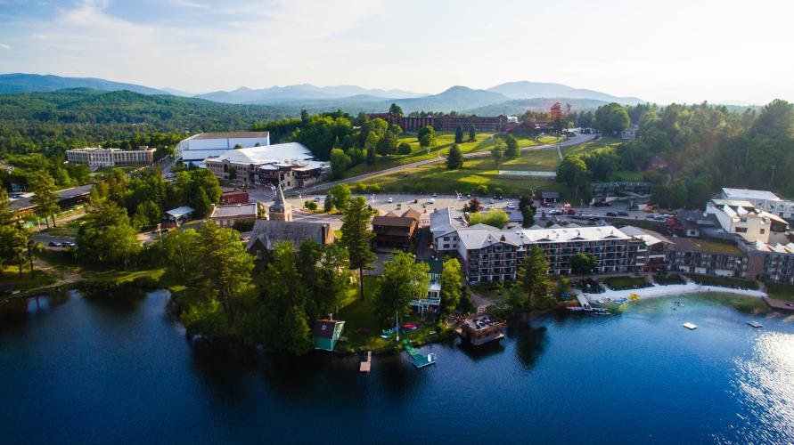 an aerial view of Lake Placid's village, including the Olympic center and part of Mirror Lake.
