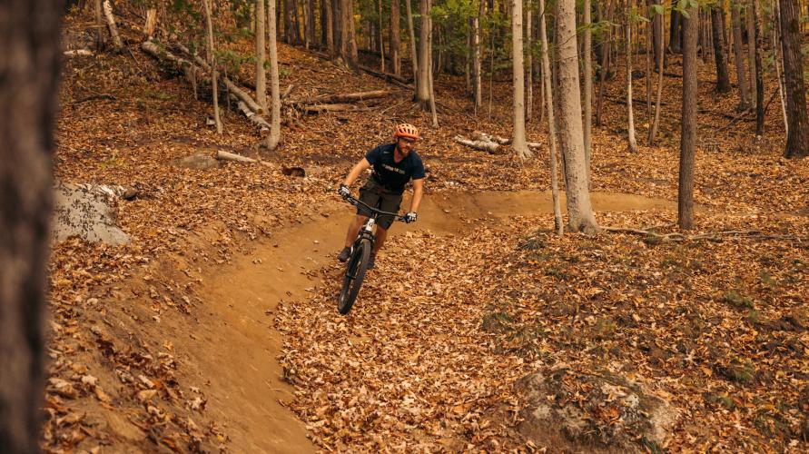 A mountain biker on a trail in late fall