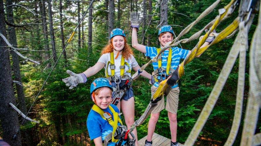 A group of kids on a high-ropes course.