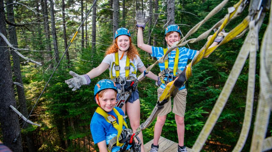 A group of kids on a high-ropes course.