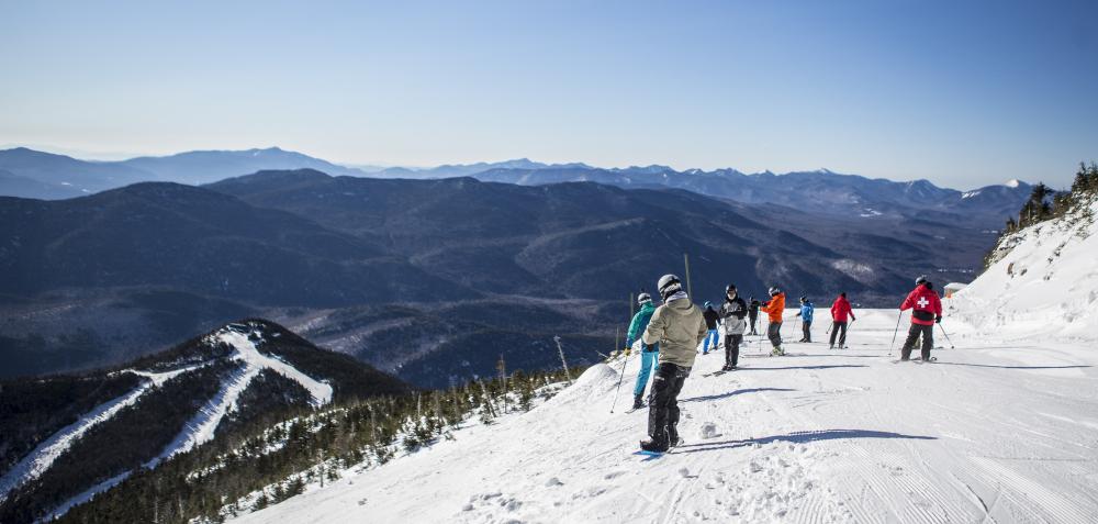 a group of skiers stop on the side of Whiteface to take in the view.