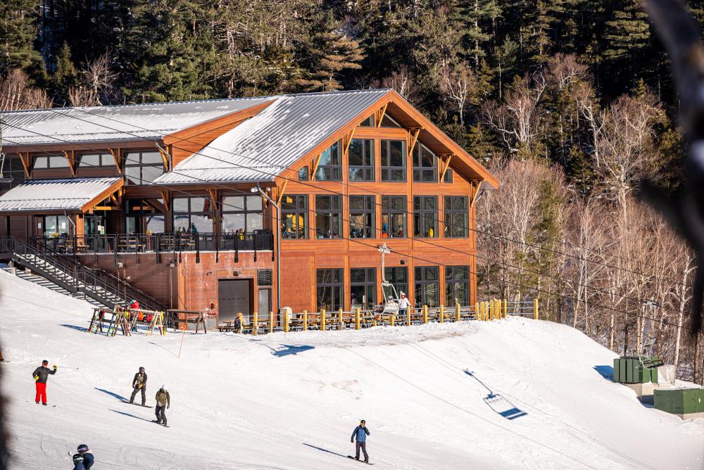 A brown nordic lodge sits on the side of Whiteface.