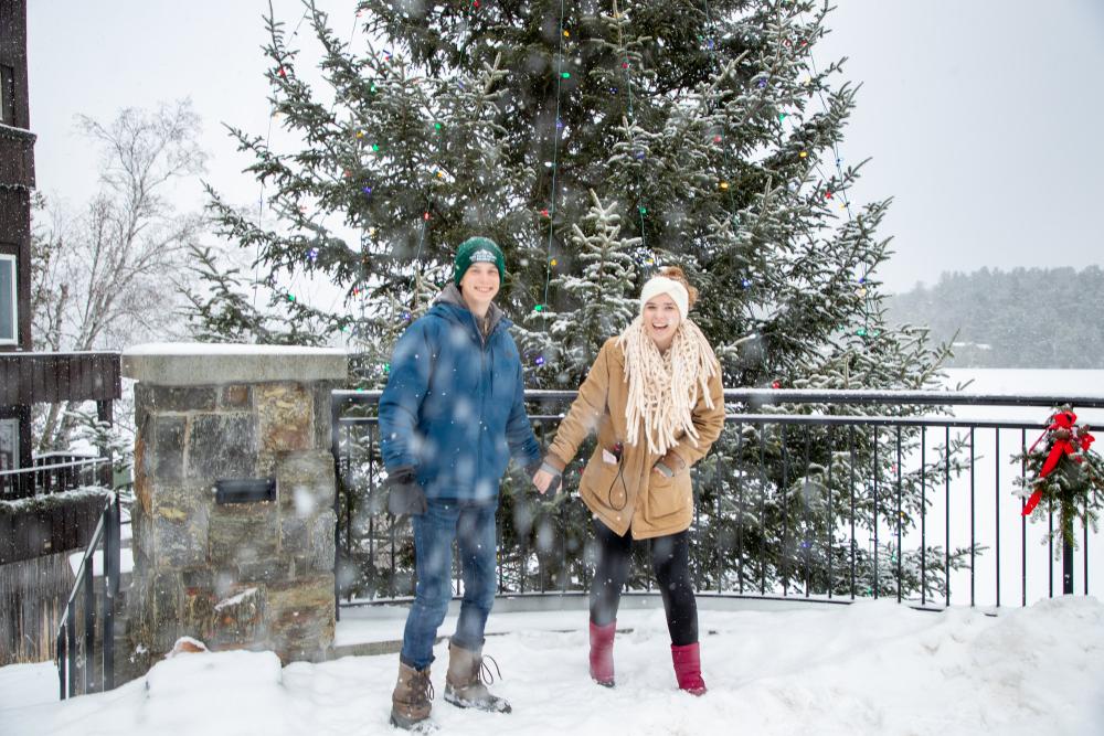 A couple walks around town on a snowy winter day