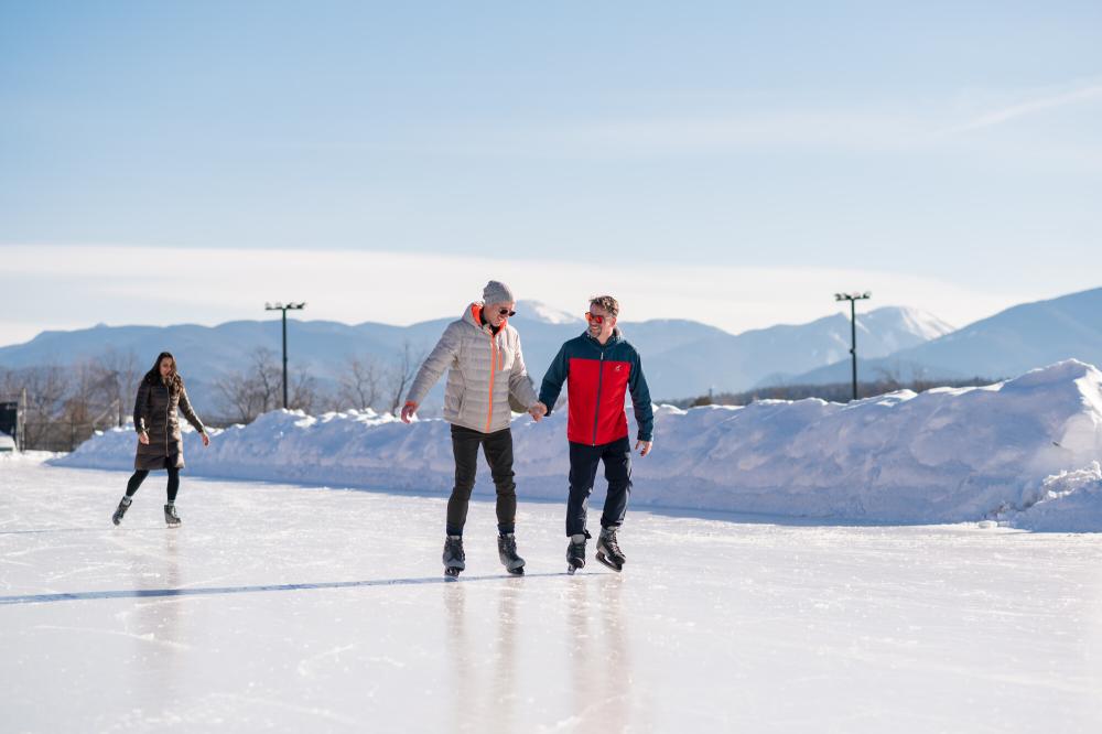 A couple skates on a scenic oval