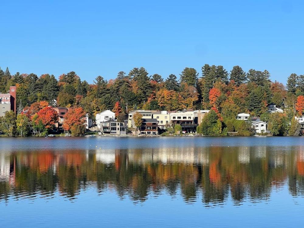 A view across the waters of Mirror Lake during peak fall foliage