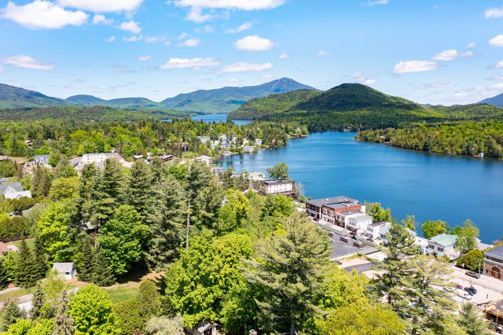 downtown lake placid in summer with whiteface mountain in the background.
