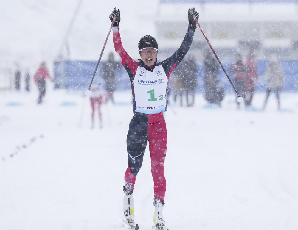 Nordic Racing events at Mount Van Hoevenberg. Athlete cheers as she crosses the finish line.