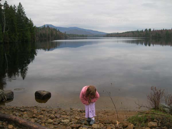 Explore the Shores of Franklin Falls Flow Pond child explores shore of Franklin Falls Pond