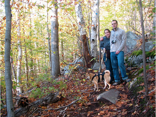 Couple hiking in woods with dog, Lake Placid, NY