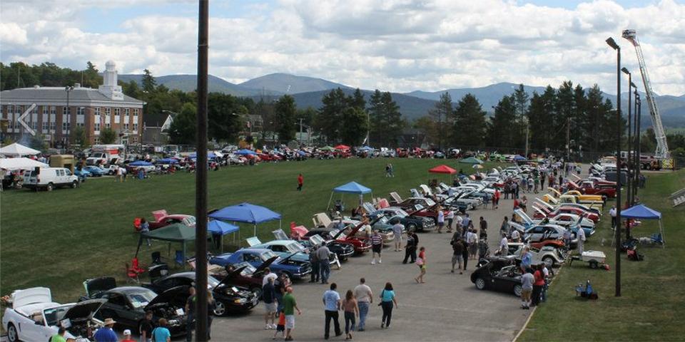 Cars lined up around the Lake Placid speedskating oval for the Annual Olympic Car show, benefiting the Lake Placid Ski Club youth programming