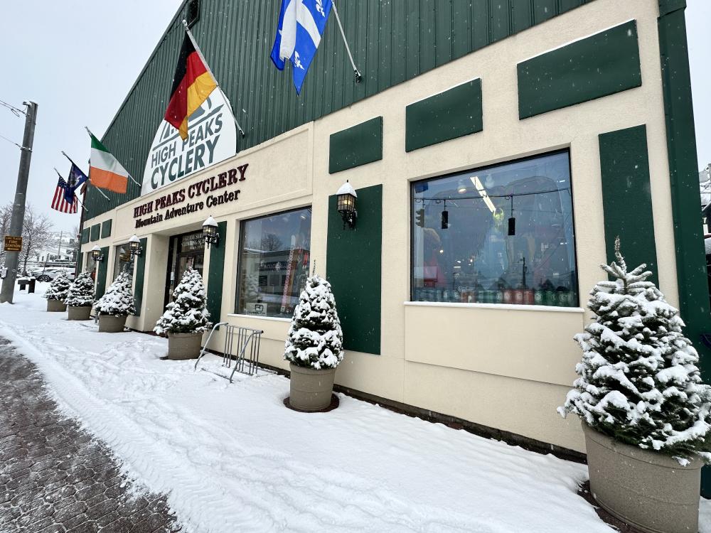 The front of High Peaks Cyclery covered in freshly fallen snow