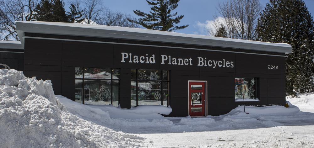 The front of Placid Planet Bicycles and it's snowy parking lot