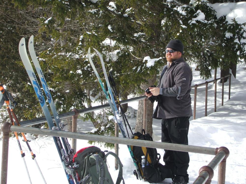 A man with cross-country skis at Marcy Dam