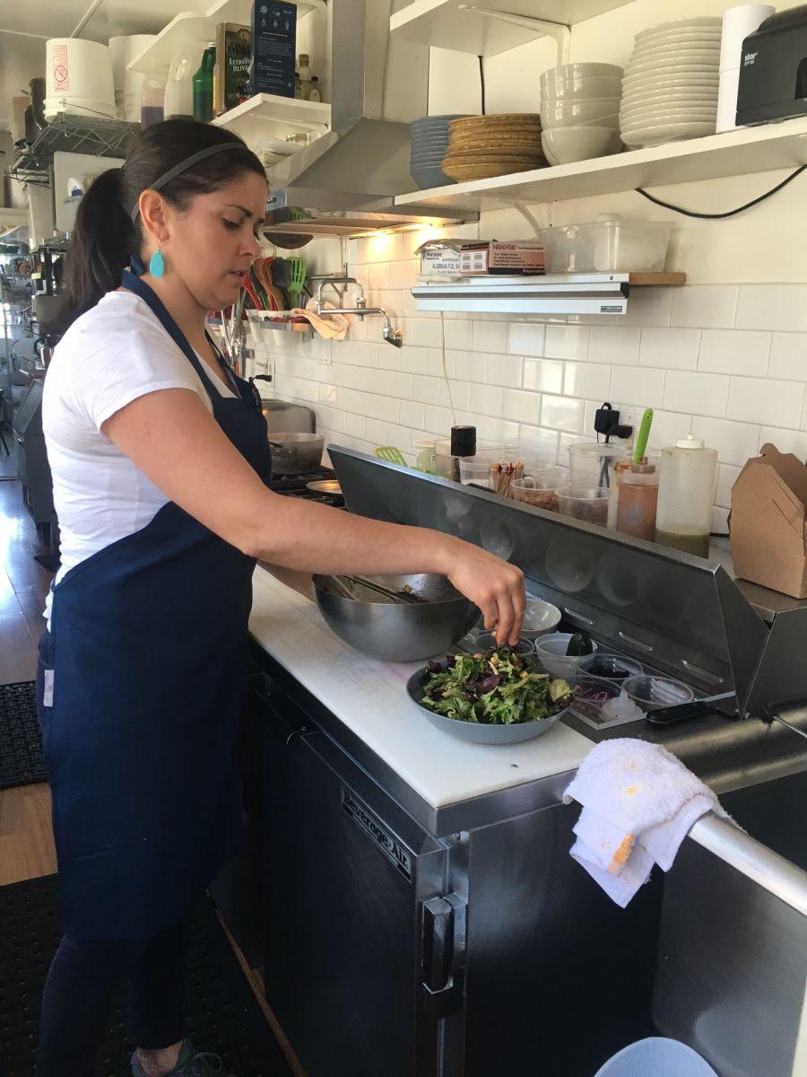 Kayte puts the finishing touches on a delicious, delicious house salad.