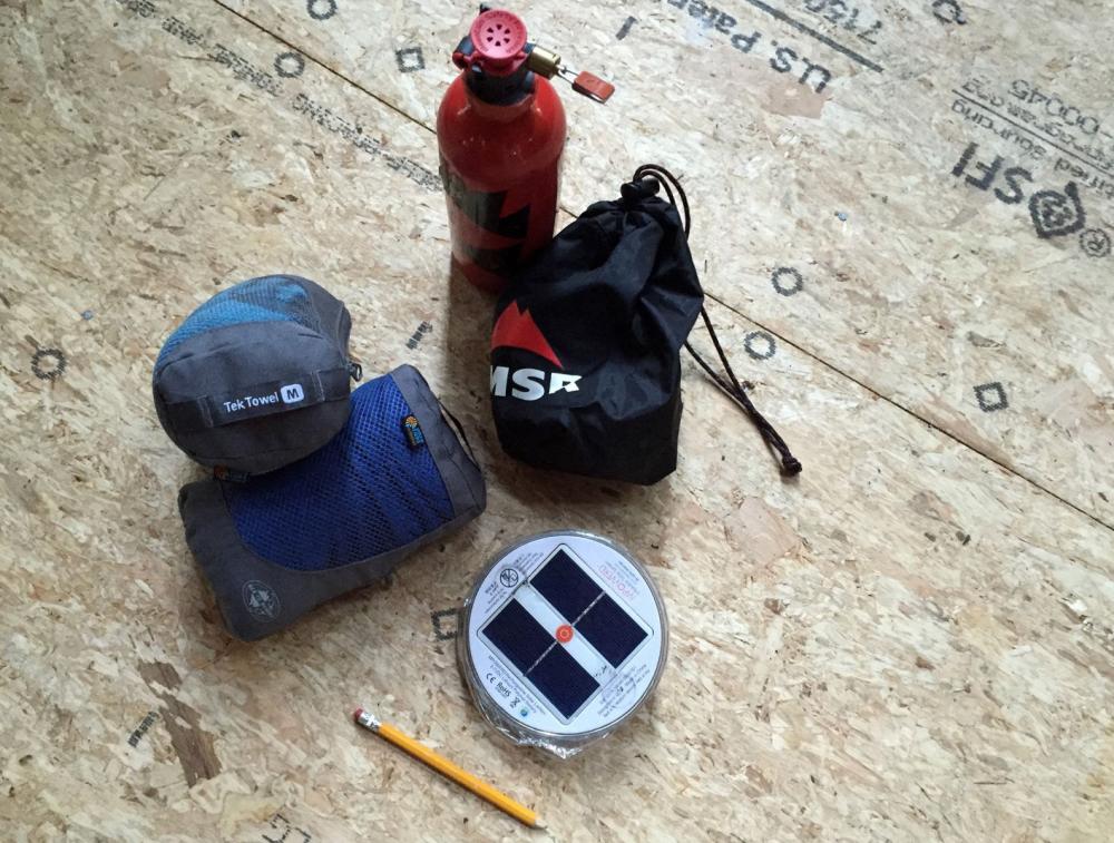 Stove, towels and lantern, with a pencil for scale.