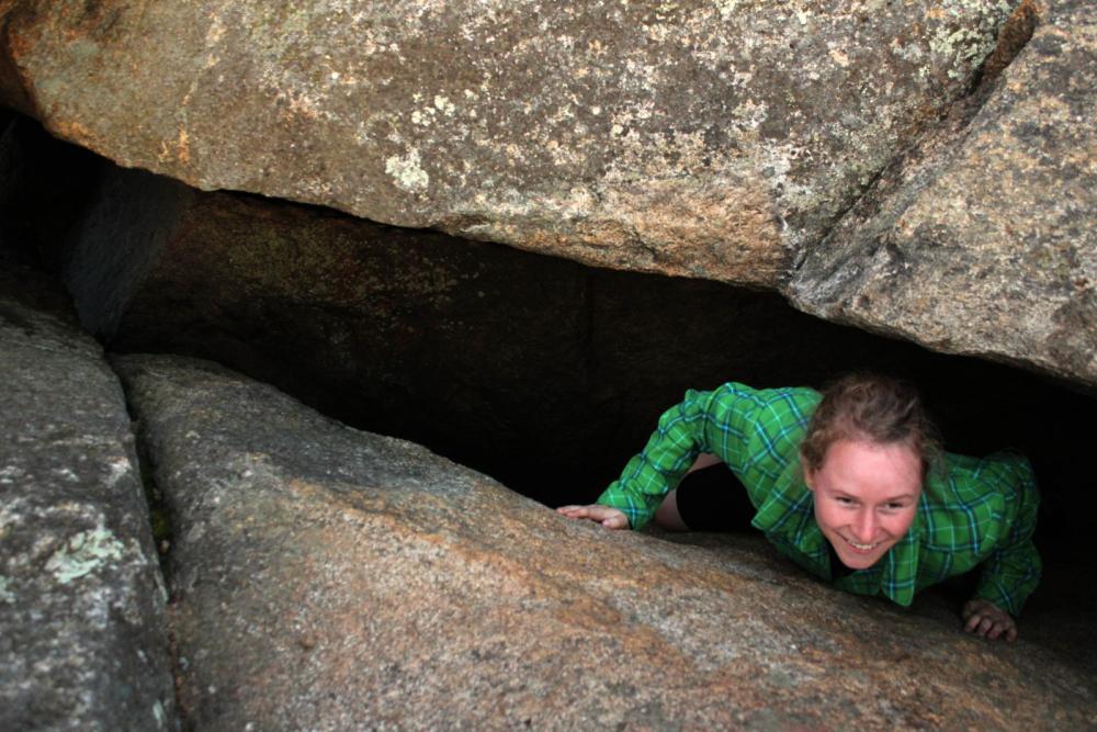 Emilee exits the cave-like crack in the ledge. Emilee exits the cave-like crack in the ledge.