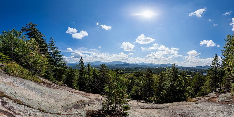 View of distant mountain ranges from the top of Cobble Hill on a sunny day.