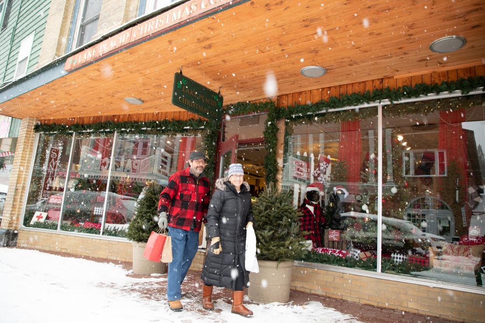 A man and woman shop Main Street on a snowy day.