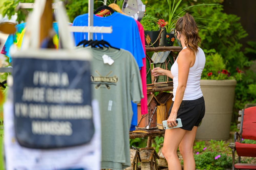 A woman browses offerings on Placid's bustling Main Street.