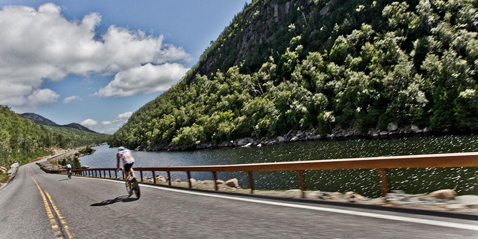 A cyclist rides past Lower Cascade Lake.