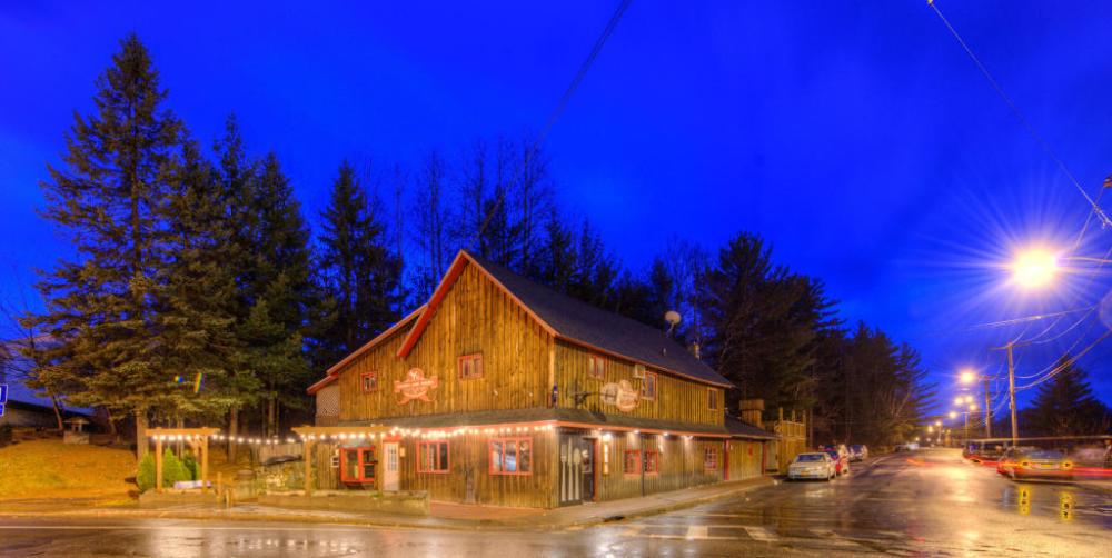 Liquids and Solids restaurant with its lights shining upon Sentinel Road at night